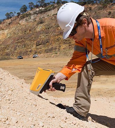 A Vanta pXRF analyzer being used to sample stockpiles