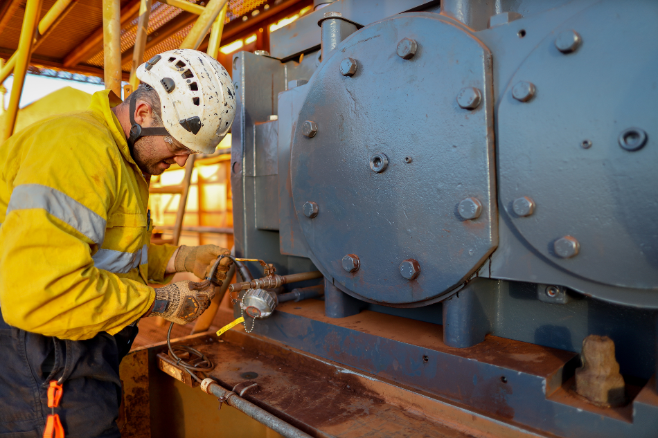 Miner electrician worker conducting safety inspection on wire cable power generator on the construction mine site plant, Sydney, Australia