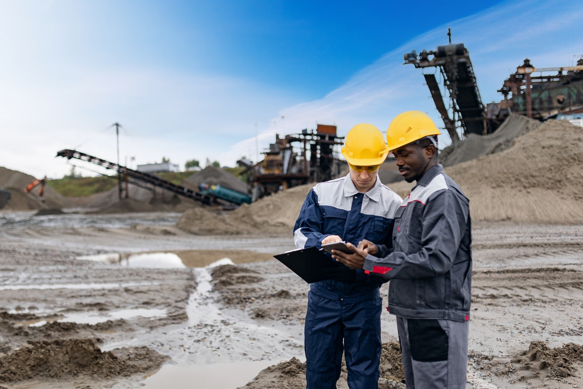 two men looking at clip board at a mine