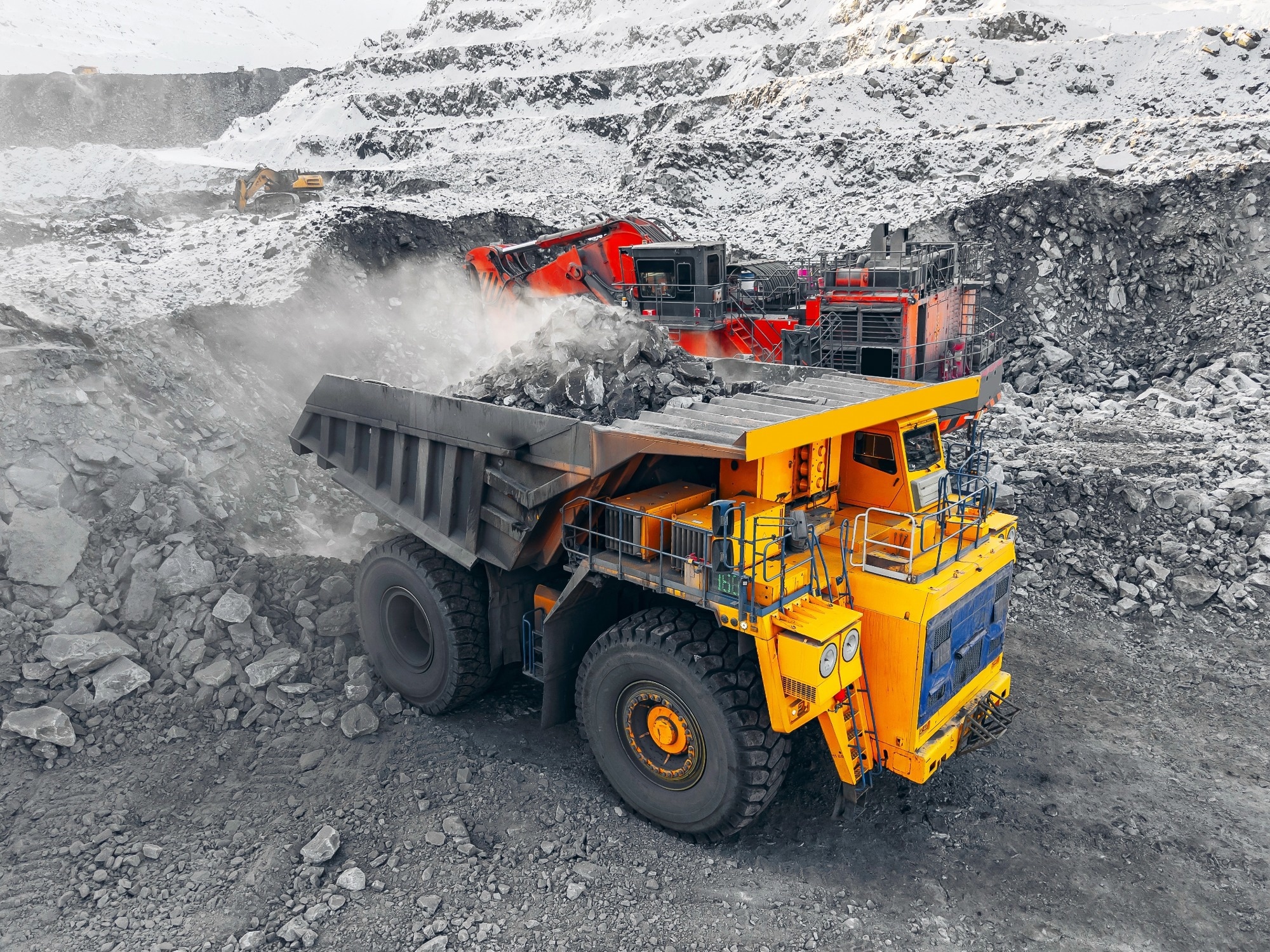 Open pit coal mine with heavy machinery truck in winter operations, mining industry banner.