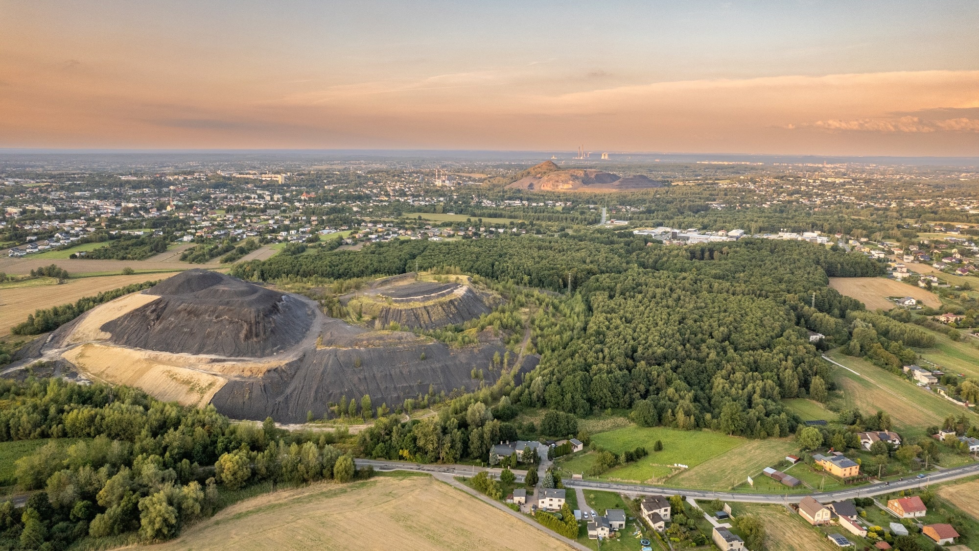 Aerial Panorama of Mining Waste Heaps and Countryside near Silesian Town at Sunset