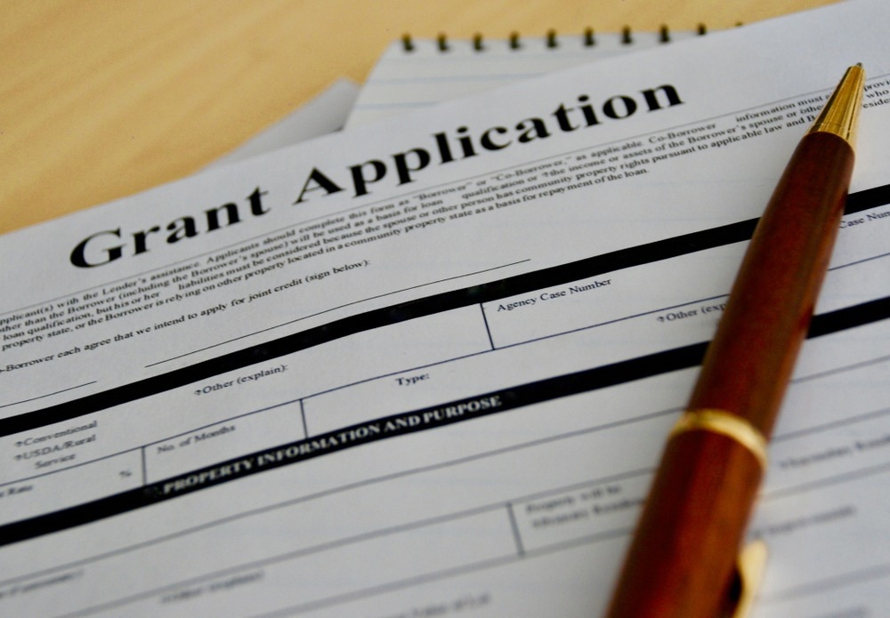 grant application form with pen