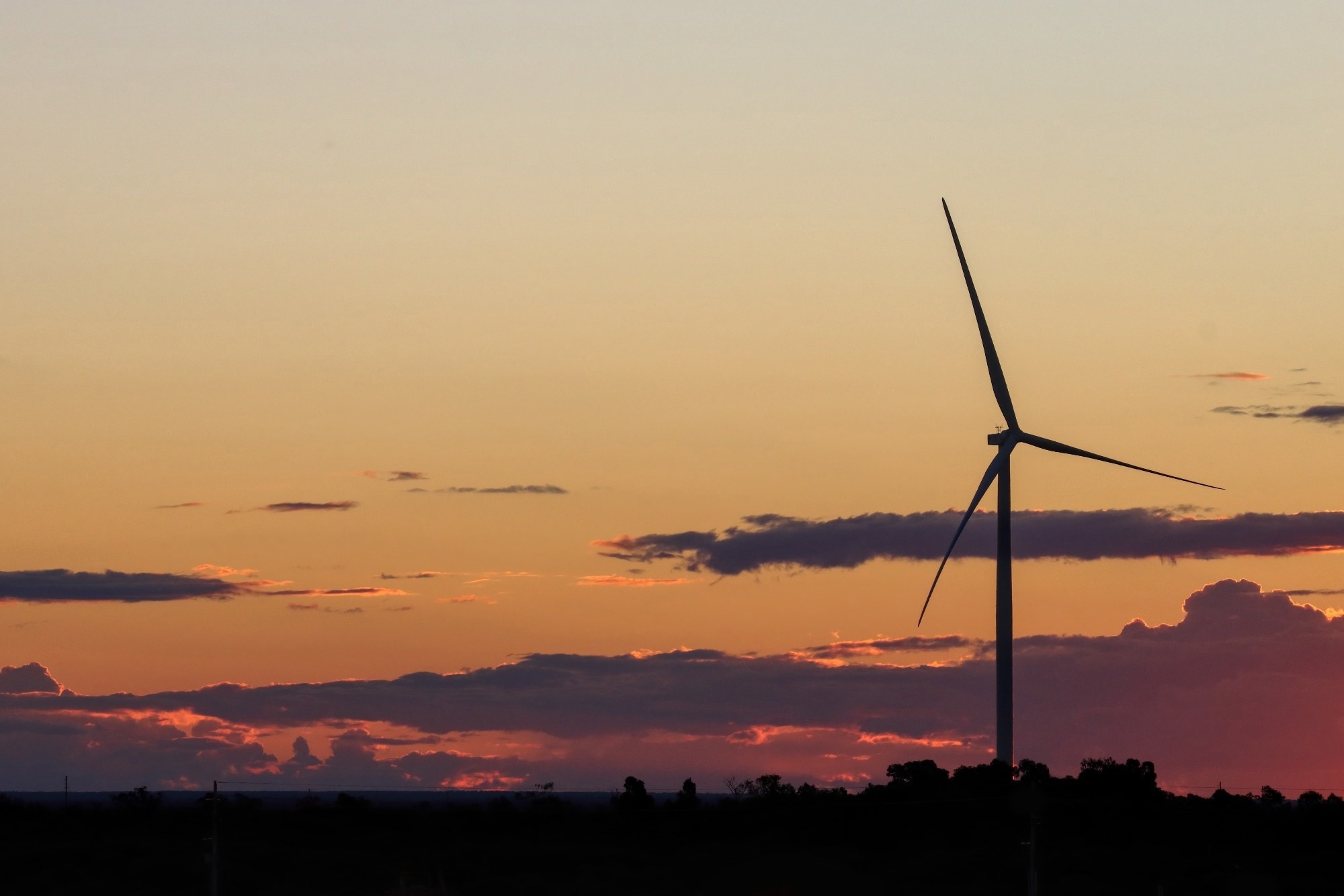 wind turbines with sunset and clouds