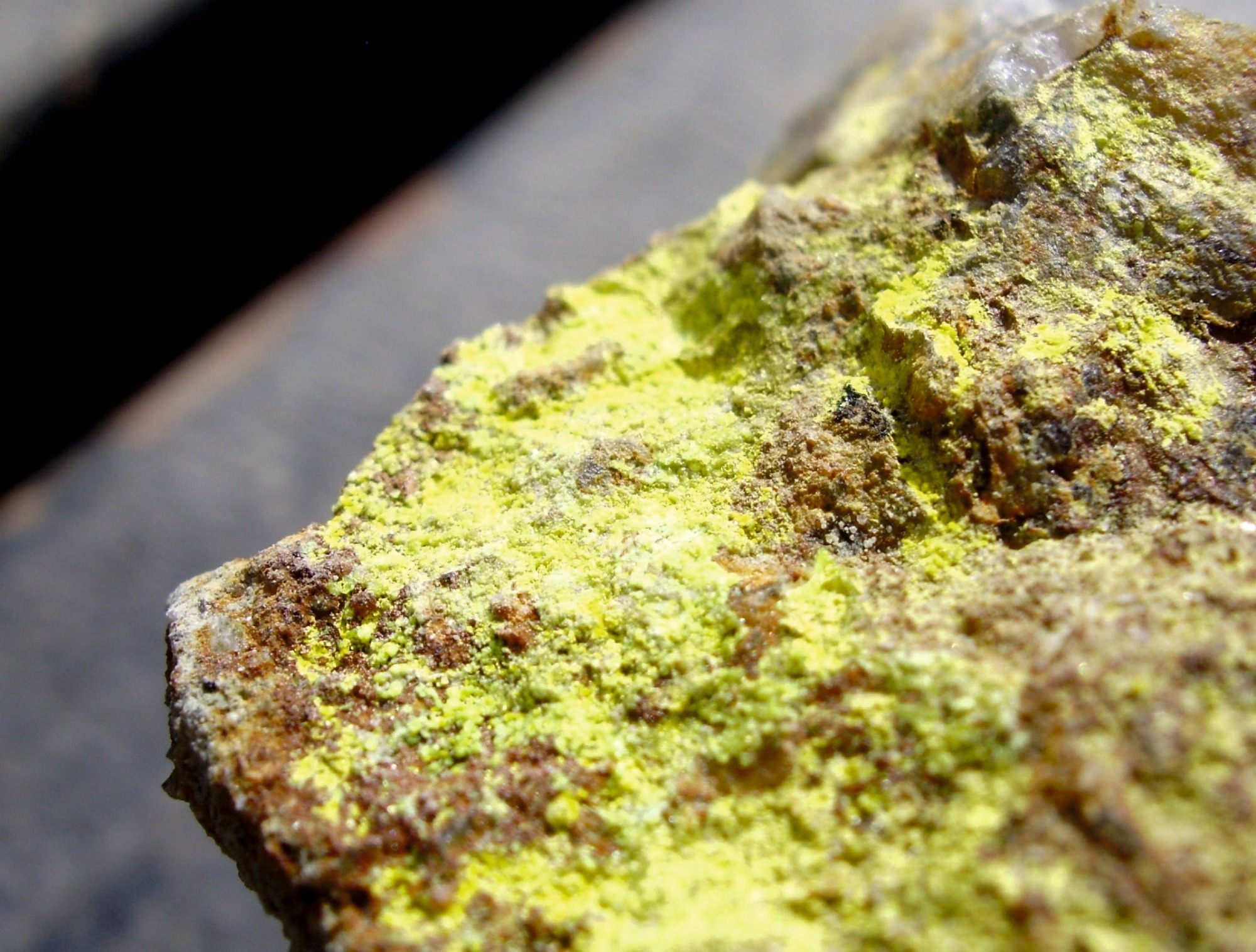 a piece of radioactive uranium rock with bright yellow coating on it