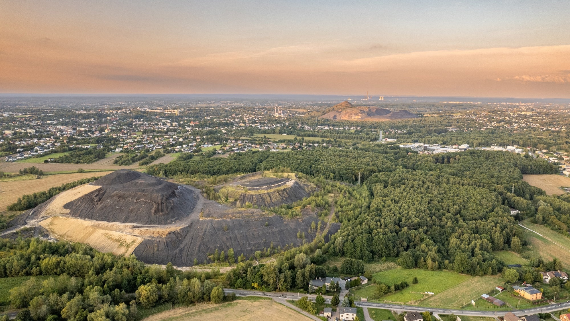 Aerial Panorama of Mining Waste Heaps and Countryside near Silesian Town at Sunset