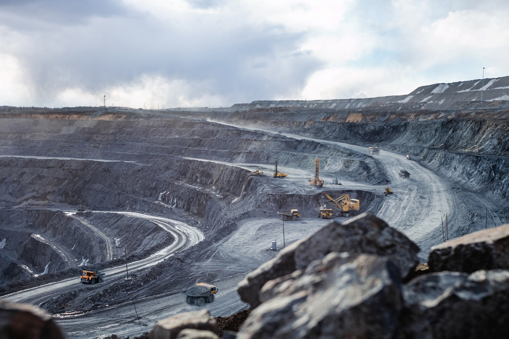 Work of heavy equipment in an open pit for mining, soft focus